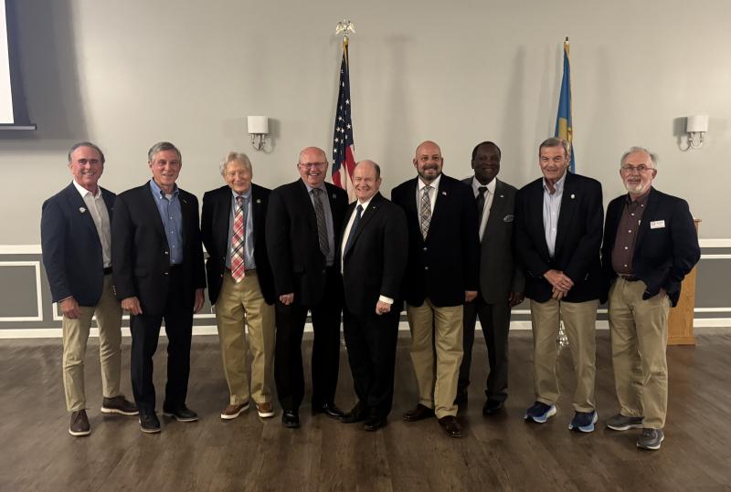 About 100 officials gathered April 24 for the Delaware League of Local Governments monthly dinner meeting. DLLG members shown with featured speaker U.S. Sen. Chris Coons are (l-r) Sen. Eric Buckson, R-Dover South; DLLG Executive Committee member and Wilmington Mayor John Carney; EC member and Millville Mayor Ron Belinko; EC vice president and Georgetown Mayor Bill West; Coons; DLLG president and Clayton Mayor Nick Smith; EC member and Milford Vice Mayor Jason James; EC member and Middletown Mayor Kenny Branner; and EC member and Bethany Beach Mayor Ron Calef.